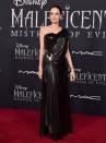 <p>Jolie kickstarted her Maleficent red carpet looks with this custom Atelier Versace one-shoulder gown, clasped at the waist with a diamond scorpion at the world premiere.<br></p>