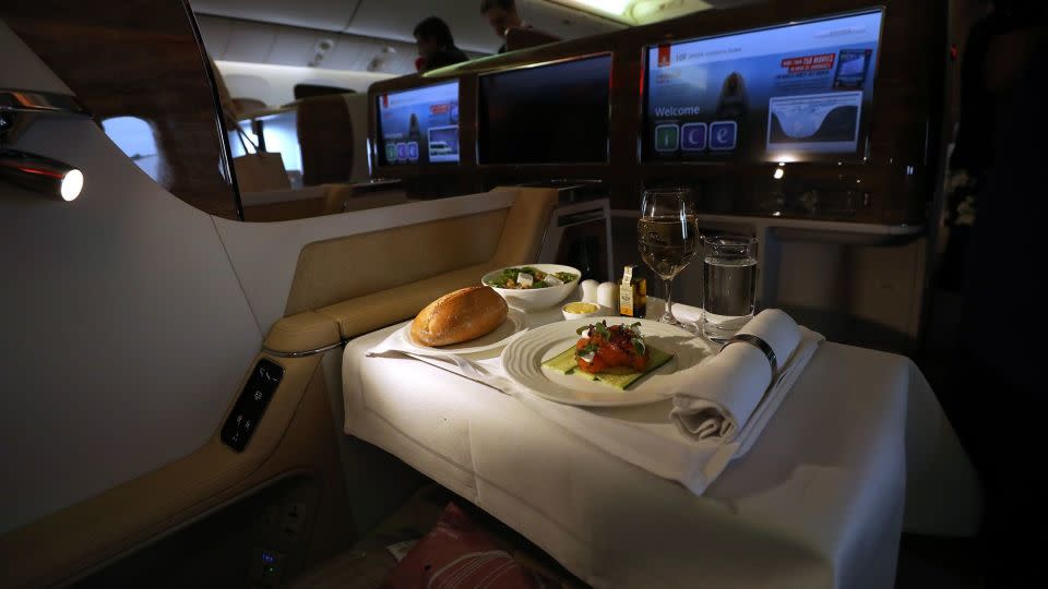 It might be tempting to make the most of business class culinary offerings, but flight attendant Kris Major says you should prioritize sleep. - Chris Ratcliffe/Bloomberg/Getty Images