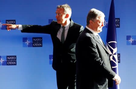 Ukrainian President Petro Poroshenko poses with NATO's Secretary General Jens Stoltenberg ahead of a meeting at the Alliance's headquarters in Brussels, Belgium December 13, 2018. REUTERS/Francois Lenoir