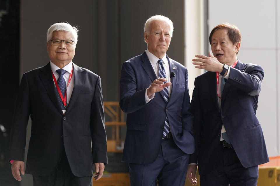 President Joe Biden tours the building site for a new computer chip plant for Taiwan Semiconductor Manufacturing Company, with Chairman Mark Liu, right and CEO C.C. Wei, Tuesday, Dec. 6, 2022, in Phoenix. (AP Photo/Patrick Semansky)