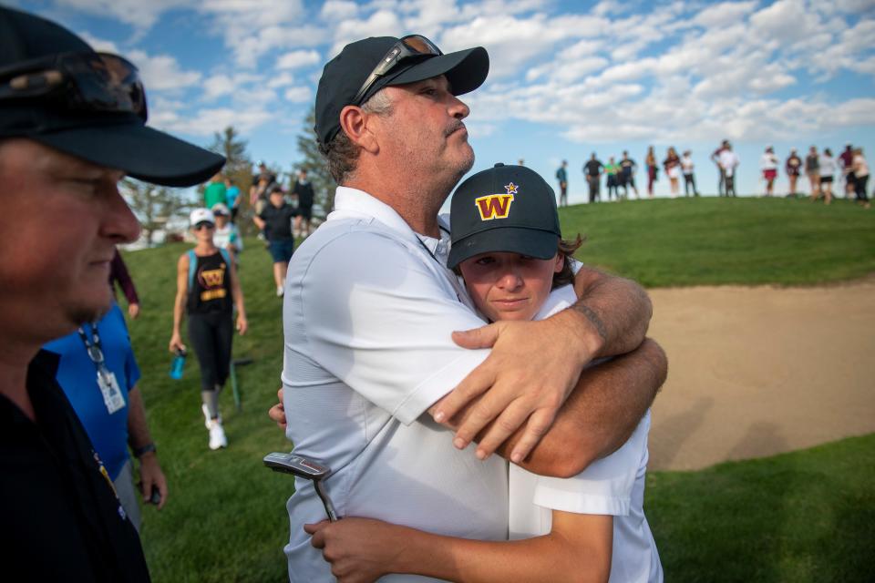 Windsor High School head coach Jason Maddox hugs his player Kellen Ball after competing in the Class 4A state boys golf championships at Pelican Lakes in Windsor on Tuesday, Oct. 4, 2022.