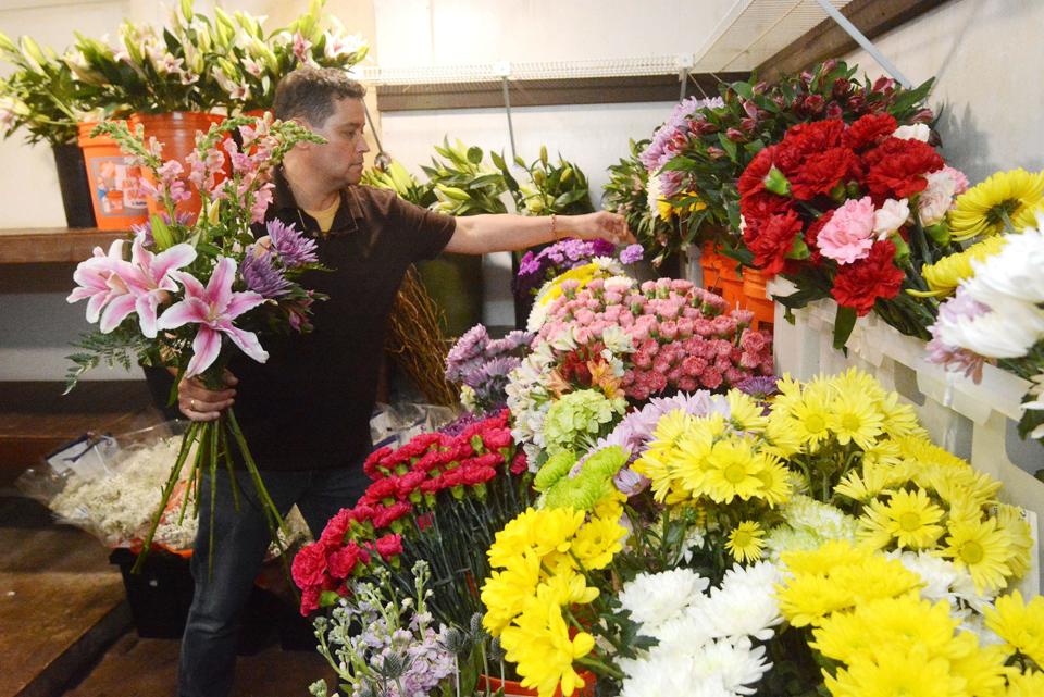 Michael Rankowitz, owner of McKenna's Flowers & Plants, prepares a Mother's Day vase arrangement Monday in the store's refrigerator at the Norwich business.
