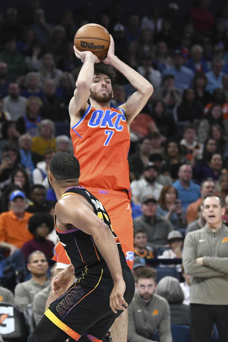 Oklahoma City Thunder forward Chet Holmgren shoots over Phoenix Suns guard Eric Gordon during the second half of an NBA basketball game Friday, March 29, 2024, in Oklahoma City. (AP Photo/Kyle Phillips)