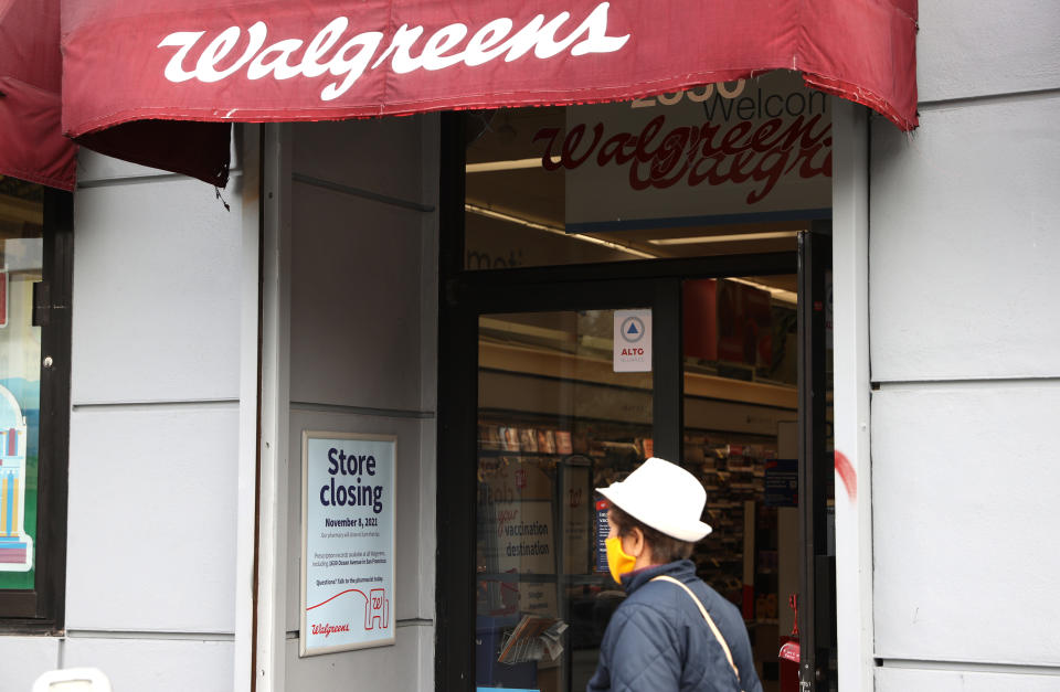 A pedestrian walks by a Walgreens store set to be closed in 2021 in San Francisco, Calif.