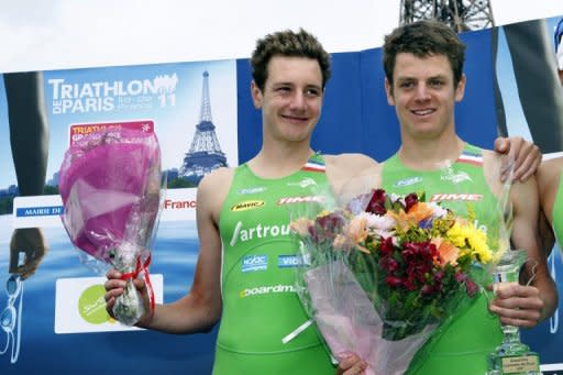 Britain's Alistair Brownlee (L) and his brother Jonathan pose on the podium after finishing first and second, respectively, at the Paris triathlon in July 2011. The two will be looking over their shoulders in Tuesday's triathlon after the women's event continued a rich tradition of Olympic surprises