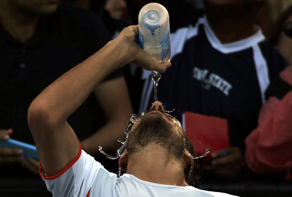 Spain's Feliciano Lopez pours water over his face after winning his second round match against Argentina's Guido Pella at the Australian Open tennis tournament at Melbourne Park, Australia, January 21, 2016. REUTERS/Tyrone Siu