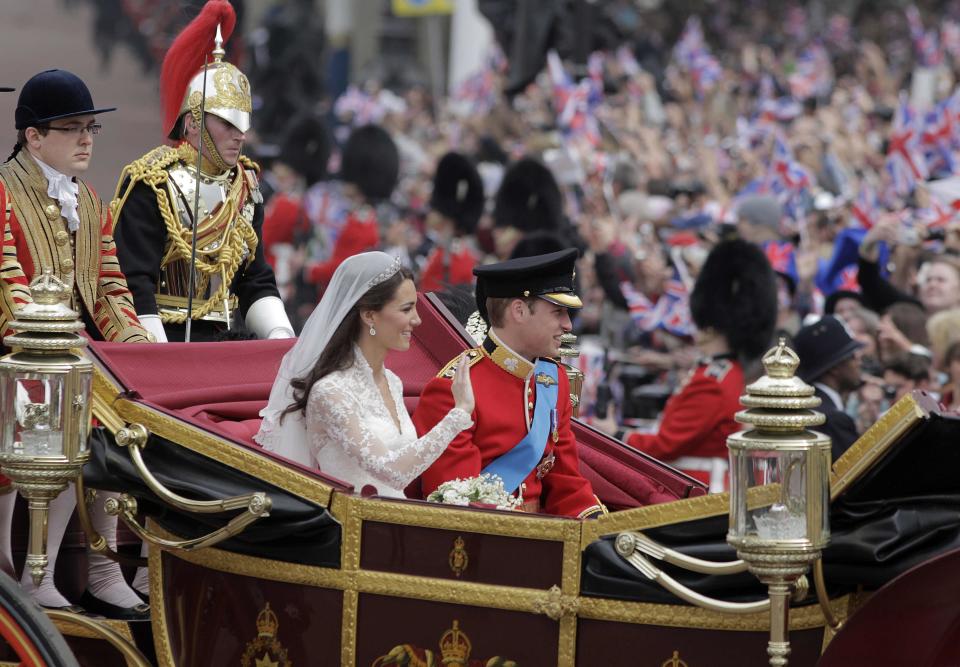 FILE - Britain's Prince William and his wife Kate, Duchess of Cambridge, make their way to Buckingham Palace after the royal wedding in London, April, 29, 2011. The pomp, the glamour, the conflicts, the characters — when it comes to the United Kingdom’s royal family, the Americans can’t seem to get enough. (AP Photo/Lefteris Pitarakis, File)