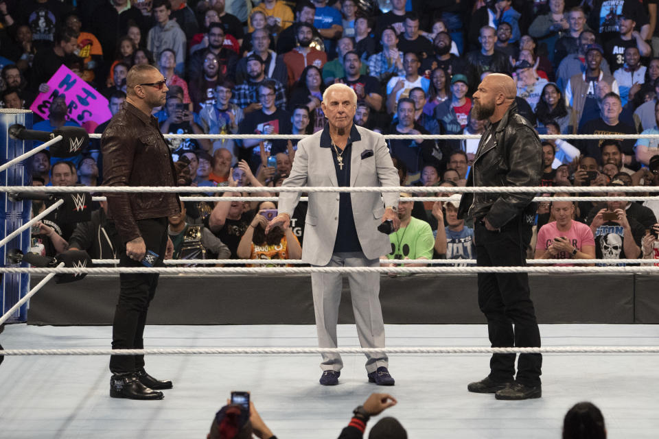 Batista, Triple H, Ric Flair share an in-ring moment at WWE's 'Smackdown' 1000 in Washington, D.C. last October. (Photo courtesy of WWE)