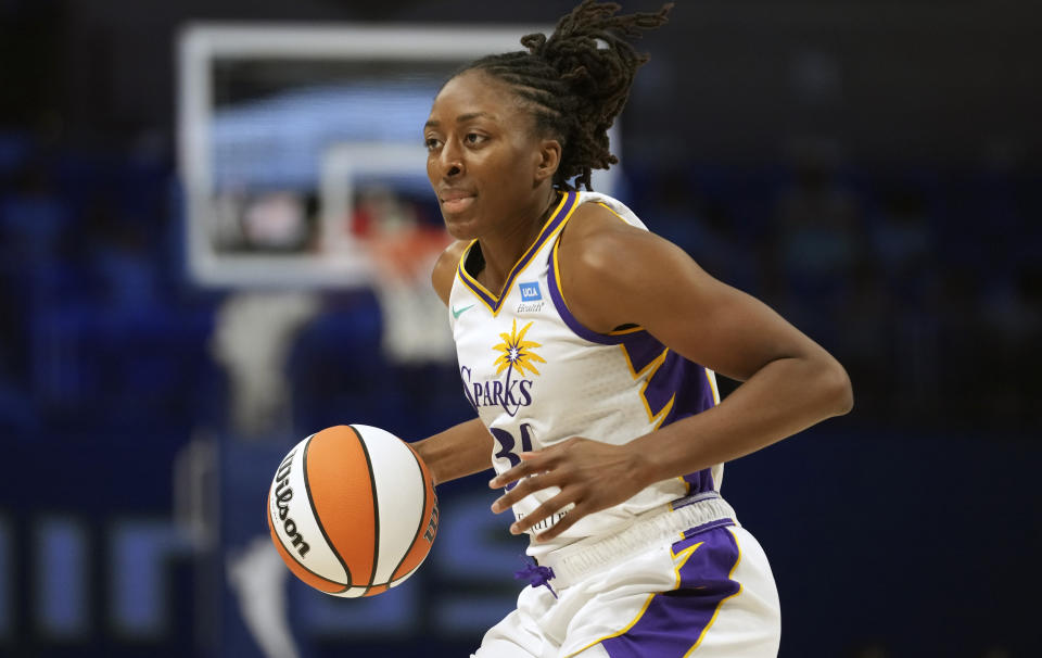 FILE - Los Angeles Sparks forward Nneka Ogwumike dribbles the ball during the second half of the team's WNBA basketball basketball game against the Dallas Wings in Arlington, Texas, June 14, 2023. The WNBA will use league-wide charter flights for the first time this season, the league announced Thursday, May 9, 2024. Ogwumike said the move is a big step forward. (AP Photo/LM Otero, File)