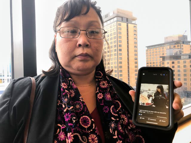 <p>AP Photo/Mark Thiessen</p> Rena Sapp holding up a photo of her sister Veronica Abouchuk