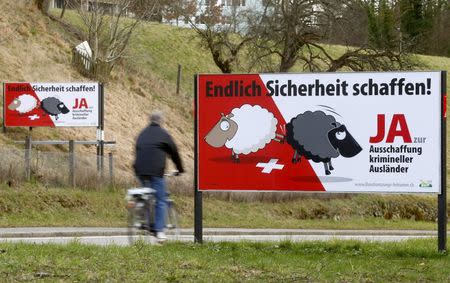 Posters of Swiss People's Party (SVP) demanding to deport criminal foreigners are displayed beside a road in Adliswil, Switzerland February 11, 2016. The posters read, "At last make things safer! Say yes to deportation of criminal foreigners". REUTERS/Arnd Wiegmann