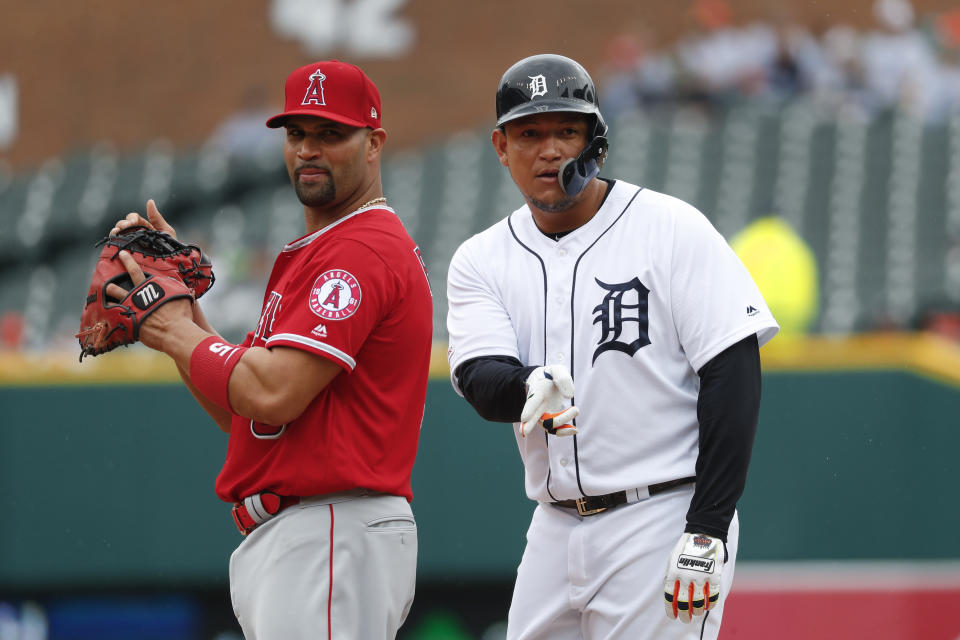 Los Angeles Angels first baseman Albert Pujols, left, listens to Detroit Tigers' Miguel Cabrera talk to the dugout in the first inning of a baseball game in Detroit, Thursday, May 9, 2019. (AP Photo/Paul Sancya)