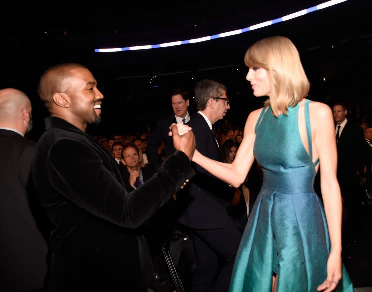 Frenemies? Kanye West and Taylor Swift shaking hands at the 2015 Grammys. (Photo: Getty Images)