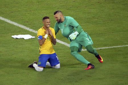 2016 Rio Olympics - Soccer - Final - Men's Football Tournament Gold Medal Match Brazil vs Germany - Maracana - Rio de Janeiro, Brazil - 20/08/2016. Neymar (BRA) of Brazil celebrates with goalkeeper Weverton (BRA) of Brazil after they won the penalty shootout and the gold medal. REUTERS/Murad Sezer