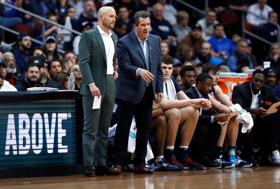 UConn assistant coaches Luke Murray, left, and Tom Moore lead the team, filling in for coach Dan Hurley, during the first half of a game earlier this season against Seton Hall.
