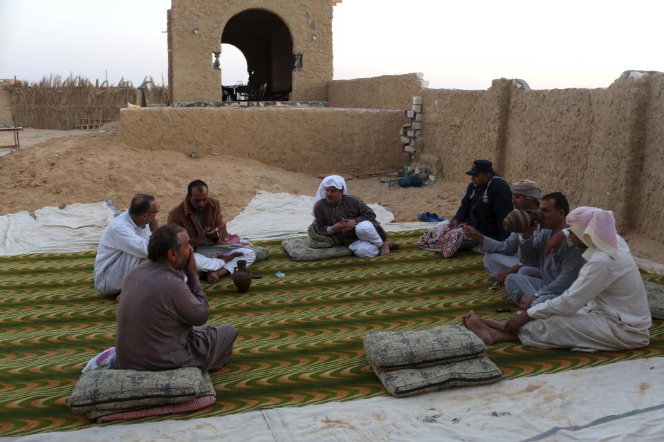 Patients relax after finishing their sand bath treatment in a rest area where they spend the night in Siwa, Egypt, August 12, 2015. (REUTERS/Asmaa Waguih)