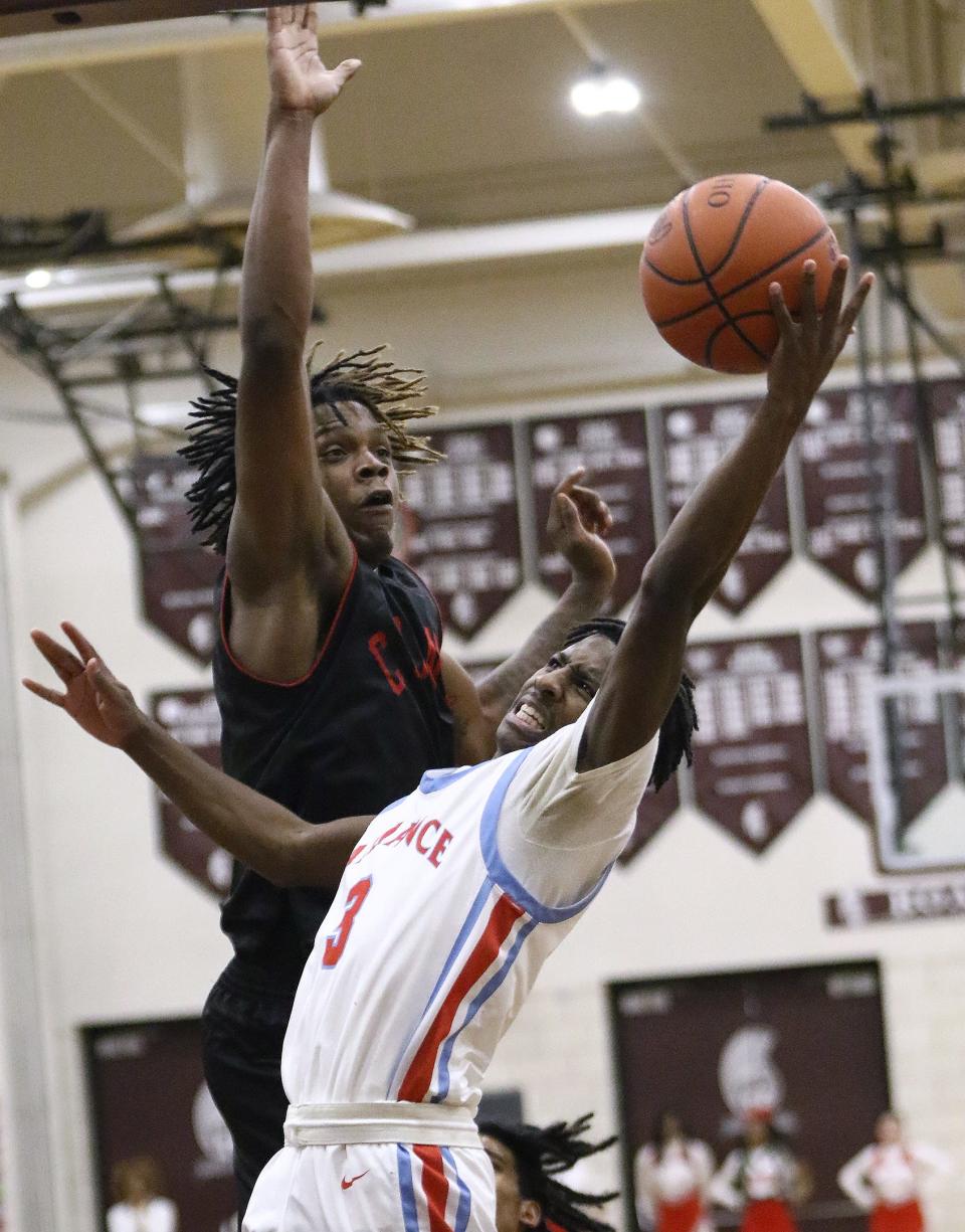 Alliance's Ramhir Hawkins, right, puts up a shot and is fouled by Chaney's Jason Hewlett in a district semifinal Thursday, March 2, 2023, at Boardman High School.