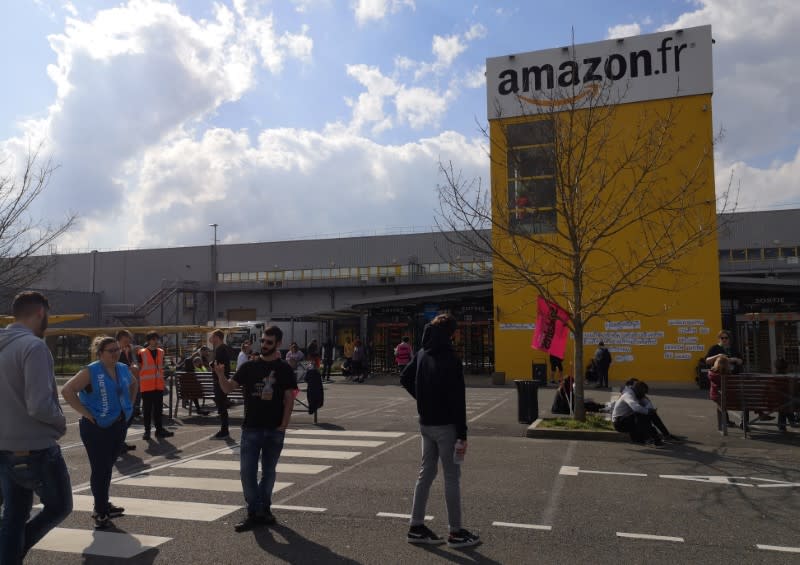 Amazon employees on strike gather outside the Amazon distribution center warehouse in Saran