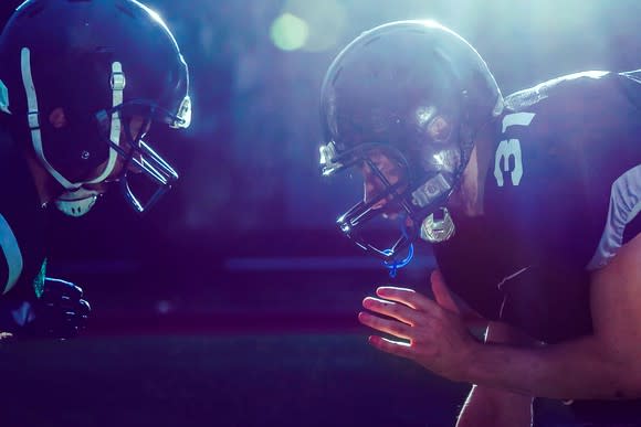 Two football players at line of scrimmage