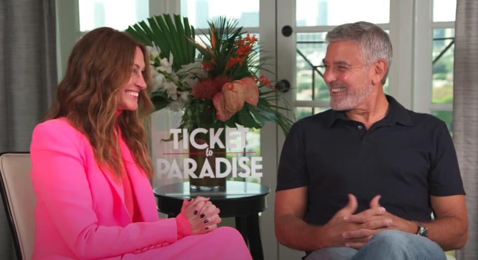 George Clooney reacts to learning how he's saved on his friend Julia Roberts' phone.