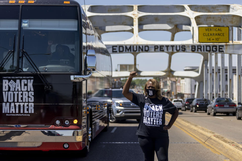 LaTosha Brown, co-founder of Black Voters Matter, stands atop the Edmund Pettus Bridge, a famous civil rights landmark, Saturday, May 8, 2021, in Selma, Ala. Brown was a keynote speaker at the John Lewis Advancement Act Day of Action, a voter education and engagement event held in Selma and Montgomery. (AP Photo/Vasha Hunt)