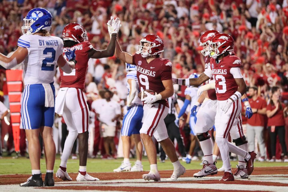 Sep 16, 2023; Fayetteville, Arkansas, USA; Arkansas Razorbacks tight end Luke Hasz (9) celebrates with wide receiver Andrew Armstrong (2) after scoring a touchdown in the second quarter against the BYU Cougars at Donald W. Reynolds Razorback Stadium. Mandatory Credit: Nelson Chenault-USA TODAY Sports