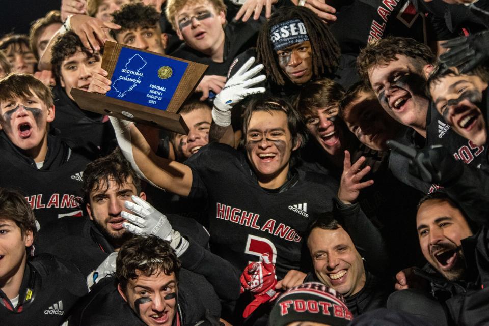 Northern Highlands hosts Ramapo in the North 1, Group 4 football title game in Allendale on Friday, Nov. 26, 2021. Senior Kyle Major (3) holds the trophy as Northern Highlands players and coaches celebrate their 35-30 victory.