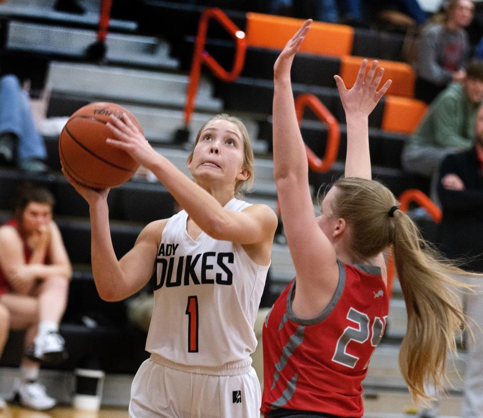 Marlington’s Maria Warner (1) takes a shot over during a game against Minerva this season.