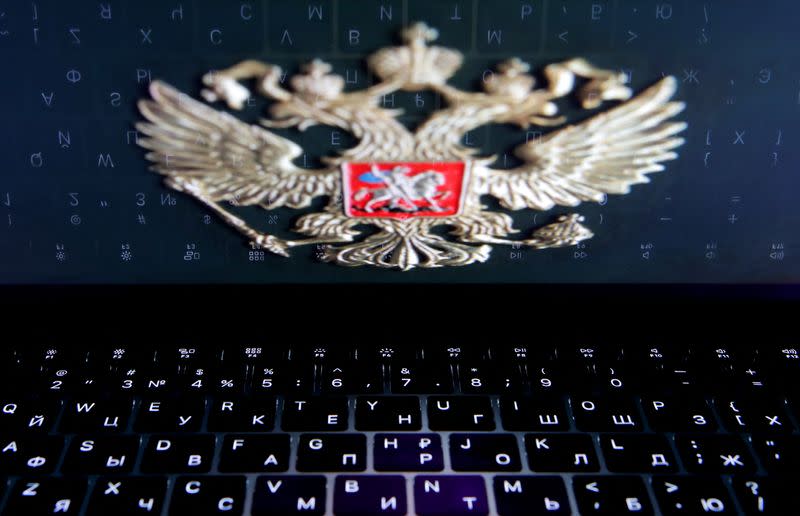 FILE PHOTO: The coat of arms of Russia is reflected in a laptop screen in this picture illustration