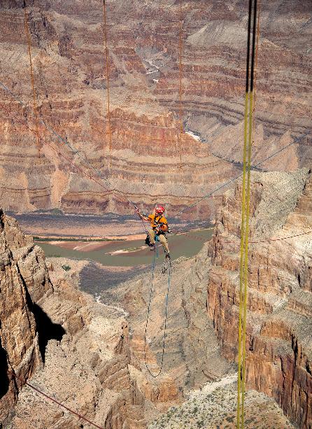 In this Tuesday, March, 25, 2014 photo provided by Abseilon USA via AZ Photos, a technician dangles from a series of ropes before polishing the underside glass at Grand Canyon Skywalk in Hualapai Reservation, Ariz. The more than 40 panes of glass underneath the horseshoe-shaped bridge on the Hualapai reservation aren’t easily accessible. The structure juts out 70 feet from the edge of the Grand Canyon, offering visitors a view of the Colorado River 4,000 feet below. (AP Photos/Abseilon USA, AZ Photos, George Walsh)