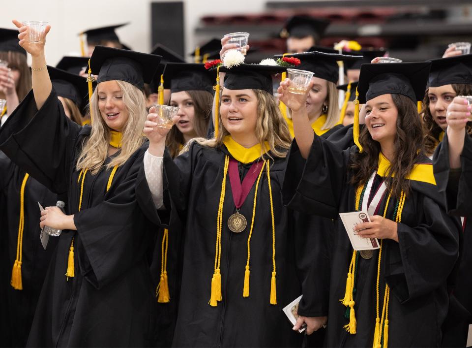 Walsh University students toast the tassel moments before their commencement ceremony Saturday.