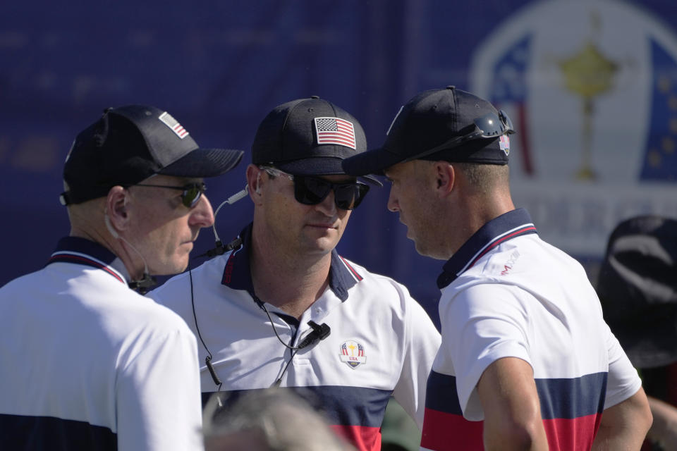 United States' Team Captain Zach Johnson, centre, speaks to United States' Justin Thomas, as United States' team vice-captain Stewart Cink looks after Thomas lost his morning Foursomes match at the Ryder Cup golf tournament at the Marco Simone Golf Club in Guidonia Montecelio, Italy, Saturday, Sept. 30, 2023. (AP Photo/Alessandra Tarantino)
