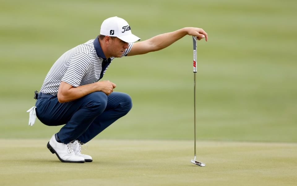  Justin Thomas of the United States lines up a putt on the 15th green in his match against Matt Kuchar of the United States - Getty Images