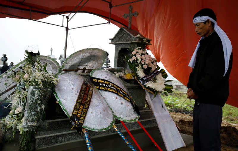 Nguyen Dinh Gia visits the newly built grave of his son Nguyen Dinh Luong, a victim who was found dead in the back of British truck, at the homeland cemetery in Ha Tinh province