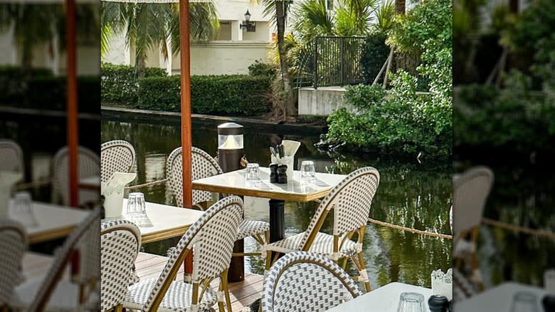 White tables beside a river