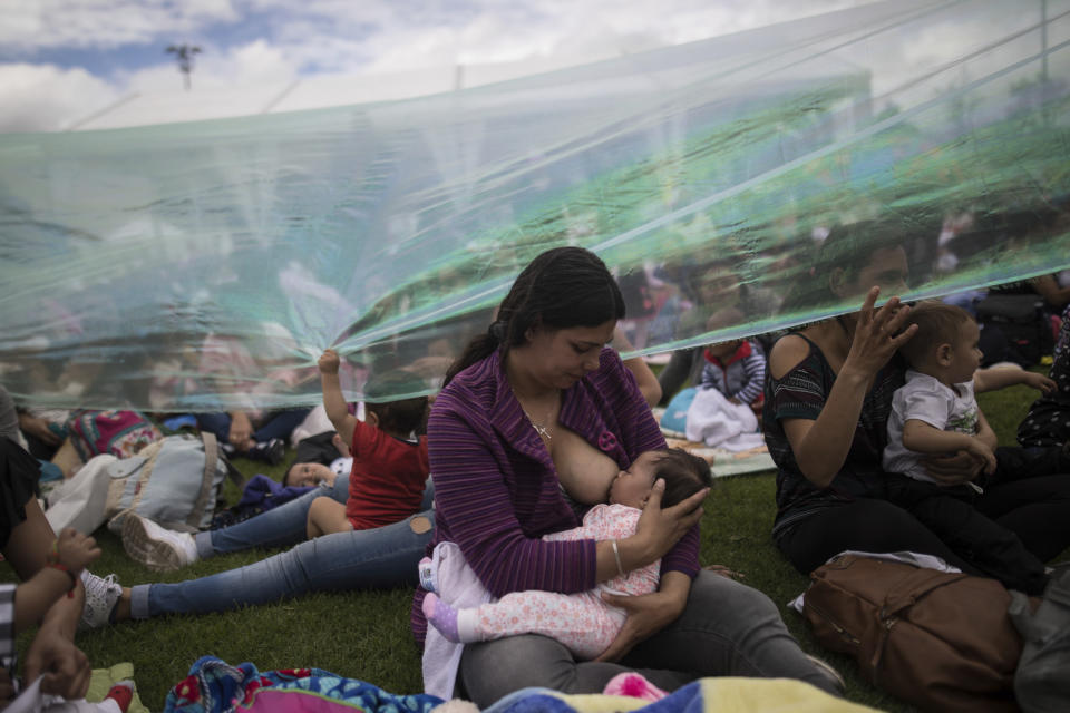 A women breastfeeds her child at a park where thousands of nursing mothers gathered for a mass feeding session to commemorate World Breastfeeding Week, in Bogota, Colombia, Friday, Aug. 2, 2019. (AP Photo/Ivan Valencia)