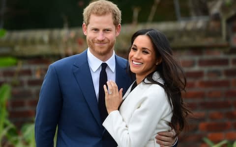 Meghan Markle shows off her wedding ring as she poses with Prince Harry - Credit: PAUL GROVER for The Telegraph