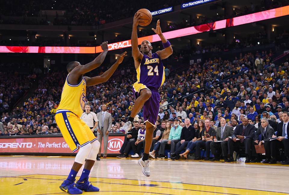 OAKLAND, CA - NOVEMBER 24:  Kobe Bryant #24 of the Los Angeles Lakers goes up for a layup over Draymond Green #23 of the Golden State Warriors during their NBA basketball game at ORACLE Arena on November 24, 2015 in Oakland, California. NOTE TO USER: User expressly acknowledges and agrees that, by downloading and or using this photograph, User is consenting to the terms and conditions of the Getty Images License Agreement.  (Photo by Thearon W. Henderson/Getty Images)