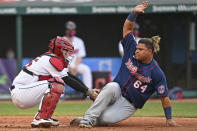 Cleveland Indians' Roberto Perez, left, tags out at home plate Minnesota Twins' Willians Astudillo, right, in the fourth inning of a baseball game, Tuesday, April 27, 2021, in Cleveland. (AP Photo/David Dermer)