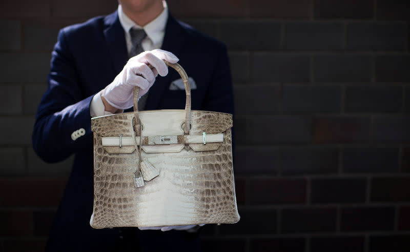 FILE PHOTO: An employee holds an Hermes diamond and Himalayan Nilo Crocodile Birkin handbag at Heritage Auctions offices in Beverly Hills, California September 22, 2014. REUTERS/Mario Anzuoni/File Photo