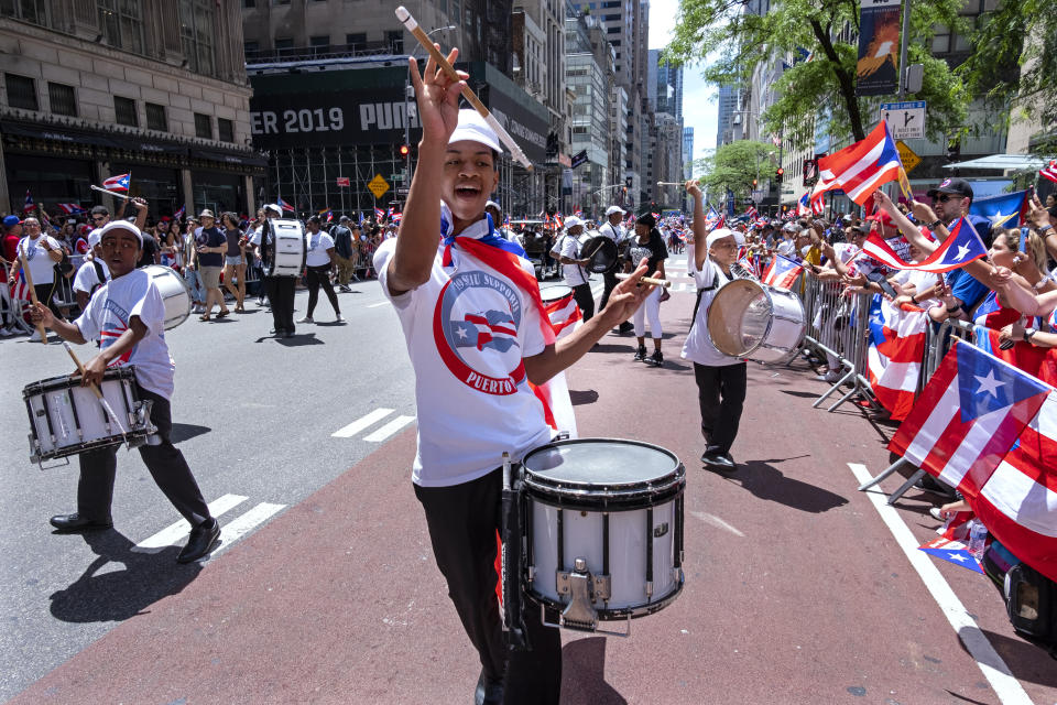 A parade unit entertains spectators during the National Puerto Rican Day Parade Sunday, June 9, 2019, in New York. (AP Photo/Craig Ruttle)