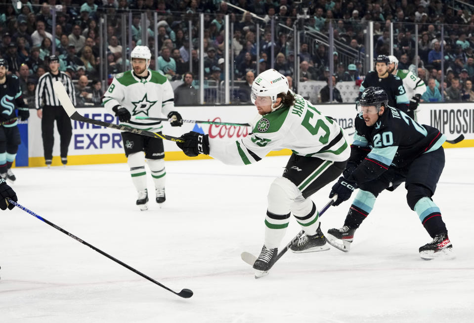 Dallas Stars defenseman Thomas Harley (55) follows through on a shot for a goal, next to Seattle Kraken right wing Eeli Tolvanen (20) during the second period of Game 4 of an NHL hockey Stanley Cup second-round playoff series Tuesday, May 9, 2023, in Seattle. (AP Photo/Lindsey Wasson)