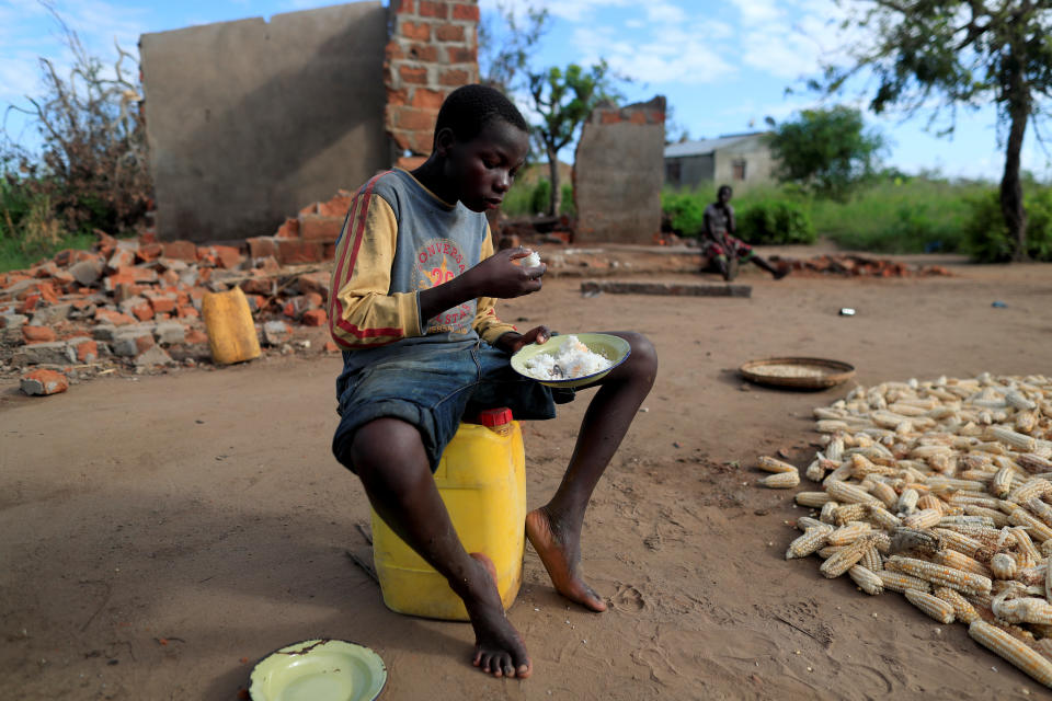 Bernado Jofresse, 14, eats rice for breakfast as he sits beside his family's damaged house in the aftermath of Cyclone Idai, in the village of Cheia, which means "Flood" in Portuguese, near Beira, Mozambique April 3, 2019. (Photo: Zohra Bensemra/Reuters)  