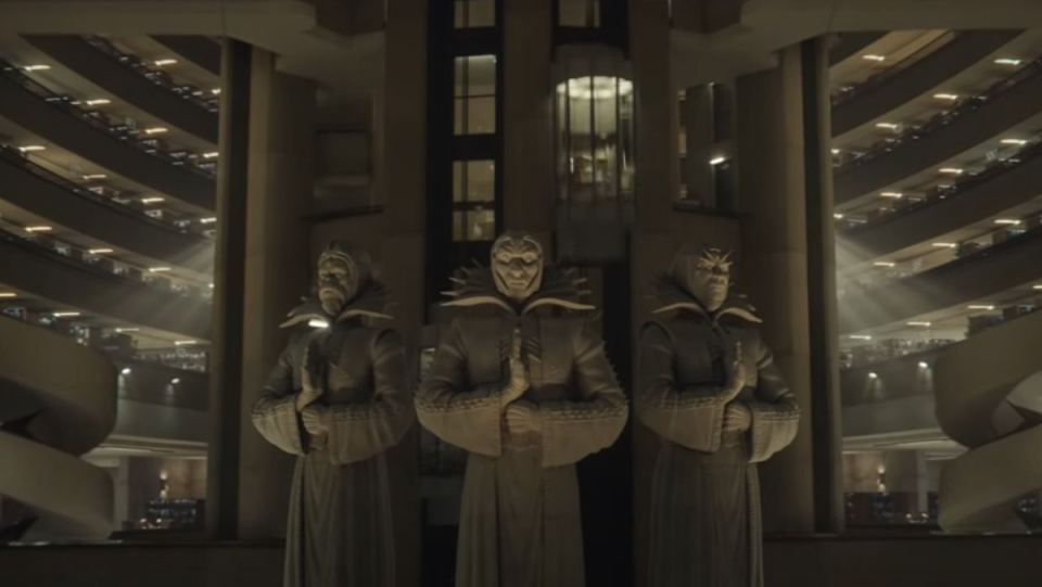 Three statues of Time Keepers in the large TVA building from Loki.