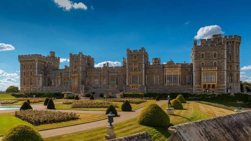 A wide view of the medieval Windsor Castle and gardens bathed in glorious sunny weather