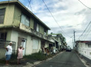 <p>Two women stand on a residential street in Bayamon, Puerto Rico on Oct. 7, 2017. Nearly three weeks after Hurricane Maria struck the island, Bayamon residents were still without power or electricity. (Photo: Caitlin Dickson/Yahoo News) </p>