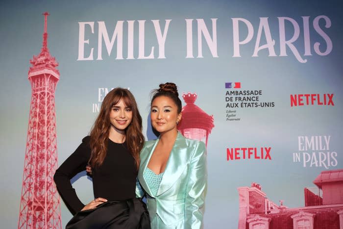 Lily posing on the red carpet with a companion