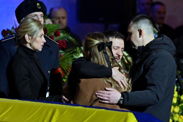 Ukrainian President Volodymyr Zelensky and his wife Olena offer relatives their condolences during the funeral ceremony of Ukrainian Interior Minister Denys Monastyrsky (AFP via Getty Images)