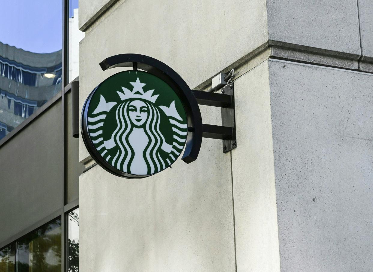 A Starbucks logo hangs over a store entrance in Washington, DC June 11, 2019. (Photo by EVA HAMBACH / AFP)        (Photo credit should read EVA HAMBACH/AFP/Getty Images)