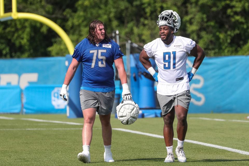 Detroit offensive lineman Colby Sorsdal talks to defensive end Levi Onwuzurike after practice during training camp at the Detroit Lions Headquarters and Training Facility in Allen Park on Sunday, July 23, 2023.